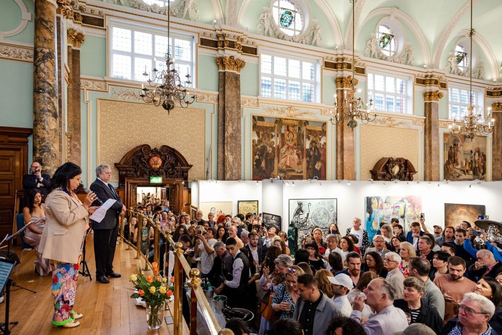 Exhibition view of the London Art Biennale 2023, with paintings hung across the gallery walls